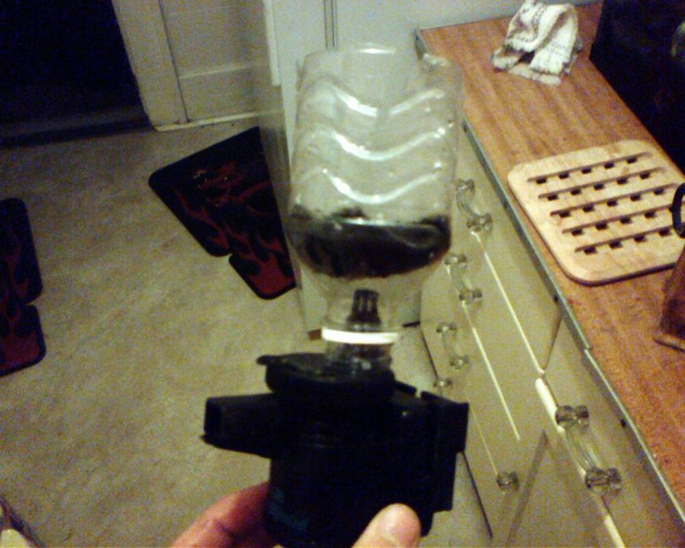 Basicly a powerhead fliped upsided with a half a soda bottle glued on with slits and a pice of...