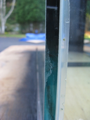 this is one of the chips in the tank corner. I wet the glass and dremeled it down so it is not sharp and I do not believe it will hurt the structural integrity of the glass. The tank doesnt leak now, so lets hope it stays that way!